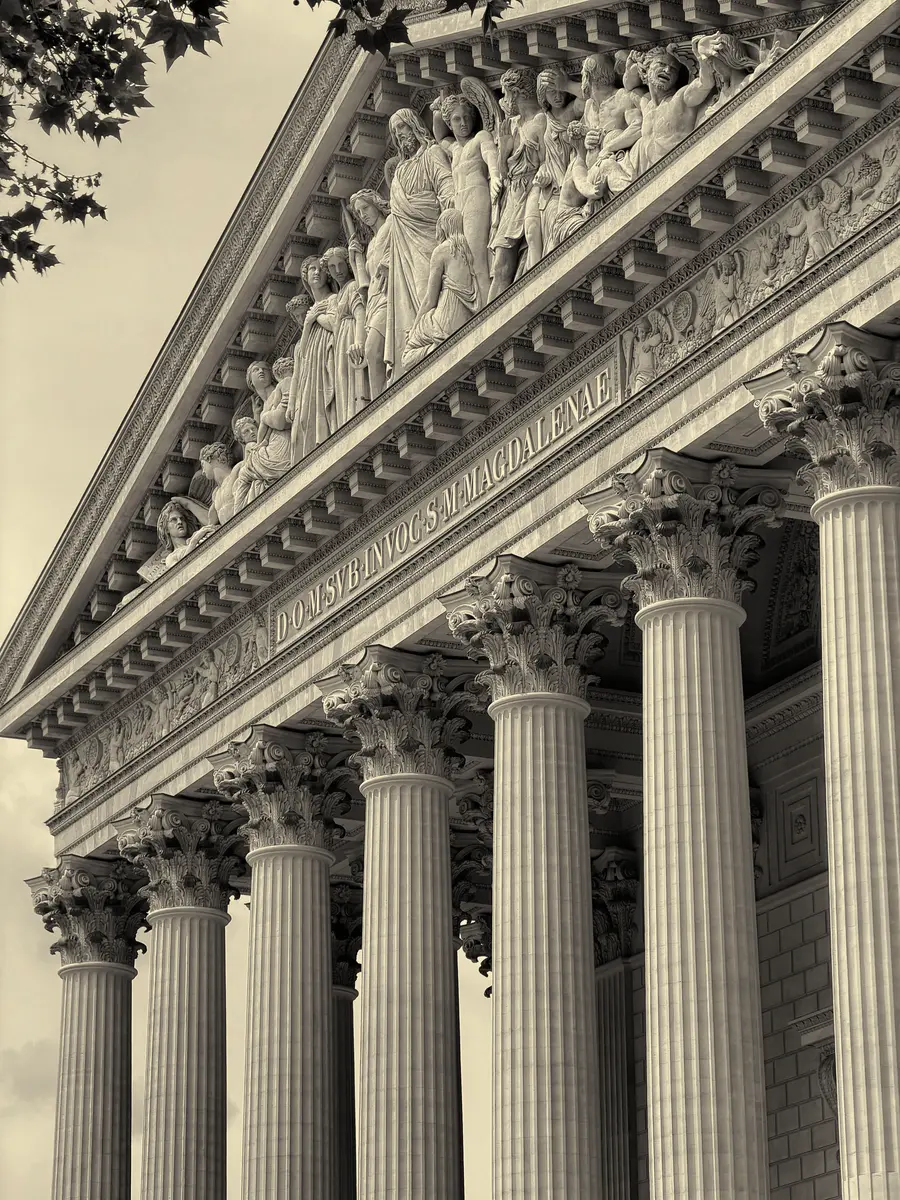 A poetic warm-sepia architectural print with a lifted Latin inscription and long progressive column shadows.